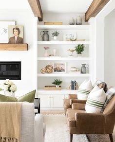 a living room filled with furniture and bookshelves next to a fire place on a wall