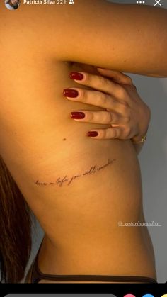 the back of a woman's body with her hand on her hip and writing in cursive ink