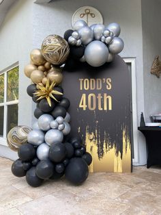 a balloon arch with black and silver balloons on it that says today's fortyth