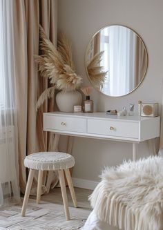 a white dressing table with a mirror and stool in front of it next to a window