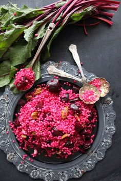 beets and other vegetables on a plate with spoons