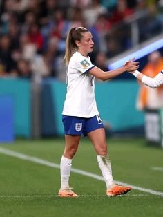 two women are playing soccer on the field