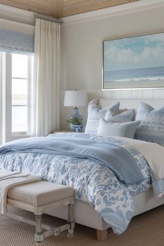 a bed with blue and white comforters in a bedroom