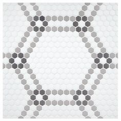 a white and gray tiled wall with hexagonal shapes in the shape of circles