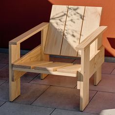 a wooden chair sitting on top of a tiled floor