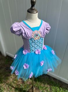 Transform your little one into a magical mermaid princess with this captivating dress. Perfect for special occasions, dress-up, and creating unforgettable moments, this dress combines whimsical design with enchanting details. Key Features: - 👗 **Enchanting Design The dress features a beautiful lavender and turquoise color scheme, reminiscent of the ocean. - ️ **Mermaid-Inspired Bodice The bodice is adorned with intricate pearl and sequin details, creating a stunning mermaid look. - 🌺 **Floral Princess Style Mermaid Tutu Dress For Dress-up, Purple Princess-style Mermaid Dress In Tulle, Purple Princess Mermaid Dress For Costume Party, Princess Mermaid Dress For Pageant, Purple Princess Mermaid Dress, Princess Style Mermaid Dress For Pageant, Princess Style Mermaid Dress For Pageants, Fitted Tulle Princess Mermaid Dress, Fitted Tulle Mermaid Dress For Dress-up