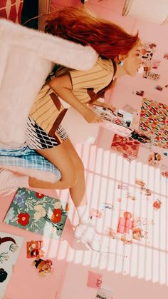 a woman sitting on top of a bed with lots of stickers all over her