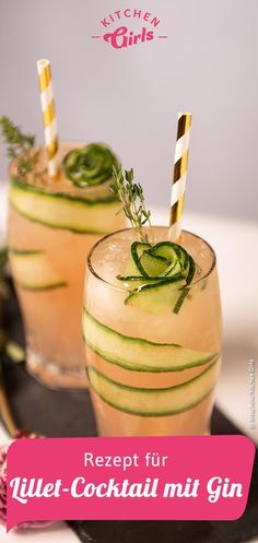 two glasses filled with cucumber cocktail on top of a table