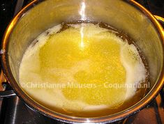 a yellow liquid is in a pot on the stove