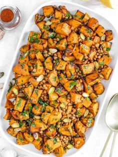 a white platter filled with sweet potatoes and lentils