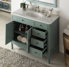 a bathroom vanity with drawers and a mirror