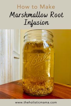 a mason jar filled with marshmallow root infussion on top of a wooden table