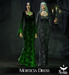 two women dressed in black and green are standing next to each other, one is holding a candle