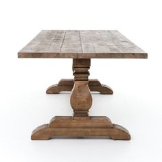 a wooden table sitting on top of a white floor