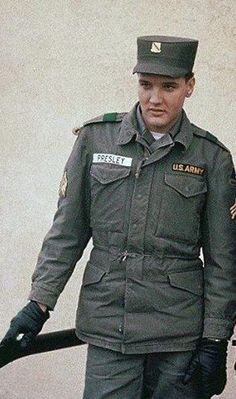 a man in uniform walking down the street