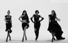 four women in black and white posing for the camera with their hands on their hipss