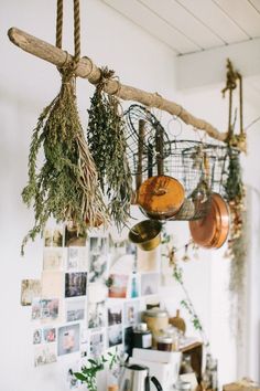 pots and pans are hanging from the ceiling