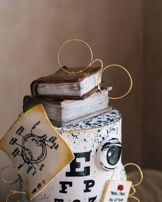 a cake made to look like a stack of books with an eyeball on top