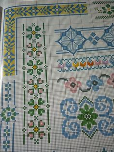 a cross stitch pattern with flowers and leaves on the bottom, is shown in blue and yellow