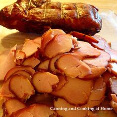 sliced meat sitting on top of a cutting board