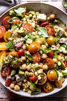 a large bowl filled with lots of different types of vegetables and garnishes