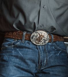 We love a classic beauty. This American Beauty Bull Rider Belt Buckle is as classic western as you can get. It is silver-finished and oval-shaped with filigree etchings. It holds a bull rider in the center that is gold-finished. It shines like a full moon in the night sky! Standard 1.5 inch belt swivel. Dimensions: Width 3.976000 Height 3.032000 Length 0.201000 Materials: 99.9% fine silver and 24K yellow gold plated over a brass base. Paint. Montana Armor to help prevent tarnish. Montana Silvers Cowboy Belt Buckle Aesthetic, Moon In The Night Sky, Cowboy Belt Buckles, Bull Rider, Cowboy Aesthetic, Cowboy Belt, Looks Country, Western Store, Western Accessories