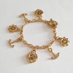 Very pretty Agatha Paris bracelet in gold plated with seven charms. Signed on the closure "Agatha Paris". Very good general condition. Bracelet length 19.5 cm. Comes in a velvet pouch. Free shipping worldwide by registered letter. See other signed items in my shop: www.etsy.com/shop/KaRaBijouxParis Do not hesitate to contact me for any additional information. Paris Bracelet, Golden Bracelet, Bracelet With Charms, Velvet Pouch, Charm Bracelets, Favorite Jewelry, Gift For Her, Etsy Accessories, Accessory Gift