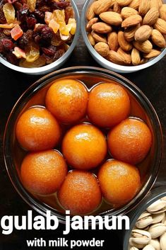 three bowls filled with nuts and oranges on top of a black table next to each other