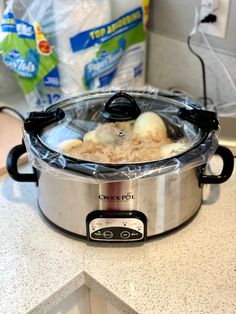 an open crock pot on top of a kitchen counter