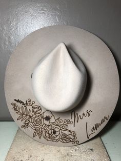 "We love our modern country brides! We design unique hats with our beautiful brides in mind, this is the perfect modern country accessory to wear on your big day and beyond! This hat is perfect for the bride who loves minimal custom design! The perfect hat for every season of weddings. These hats are felt/wool with a wide, flat brim.  Sizes vary for different colors. For Cream and Silverbelly sizes are small, medium, and large. Ivory hats are one size fits all. Hats come in four colors; Cream, S Burned Wedding Hat, Bride Felt Hat, Western Wedding Hat, Custom Wedding Hats, Bridal Cowgirl Hat, White Fedora Mini Hat For Wedding, White Wedding Hat (one Size Fits Most), White Wedding Hats One Size Fits Most, White Wedding Hat, One Size Fits Most