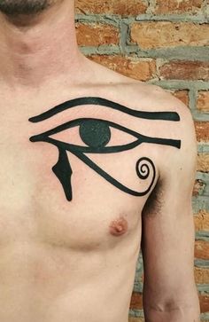 a man with an eye tattoo on his chest