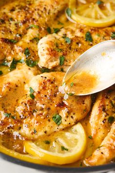 a pan filled with chicken, lemons and parsley