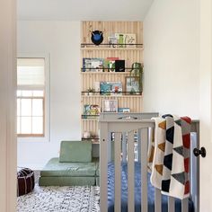 a baby's room with a crib and bookshelf in the corner