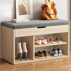 a wooden bench with shoes on it and a handbag next to the shoe rack