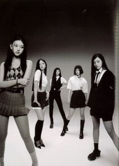 black and white photograph of young women in school uniforms, posing for the camera with their arms crossed