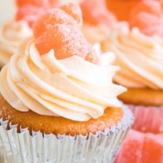 cupcakes with white frosting and orange icing