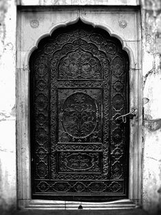 an ornate iron door in black and white