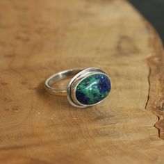 This is the perfect East-West Oval Ring and this Azurite Malachite is so gorgeous, revealing the classic blue of Lapis Lazuli and green of Malachite. The 10X14mm stone rests perfectly in this east west oval configuration. Simple and perfect with just an edge of .925 Sterling Silver. Wear this Azurite Malachite Statement Ring alone or on a hand full of rings. All traditional Silversmithing is done in my Baltimore MD studio. Azurite Malachite 10X14mm Ring top 14X18mm .925 Sterling Silver All tradi Hand Full Of Rings, Chloe Ring, Pink Opal Ring, Malachite Ring, Vintage Silver Jewelry, Malachite Rings, Purple Amethyst Ring, Purple Rings, Lapis Ring