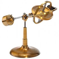 an antique brass desk lamp on a metal base with two lights attached to the top