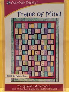 the front cover of a quilt book with an image of a square pattern on it