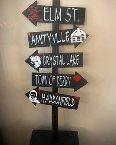 a wooden sign with many different signs on it