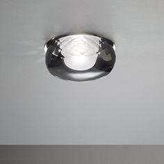 a light that is on the ceiling in a room with white walls and flooring