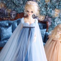 two dolls dressed in blue and pink gowns