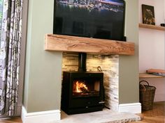 a flat screen tv mounted above a fireplace