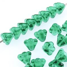 green heart shaped glass beads on a white background