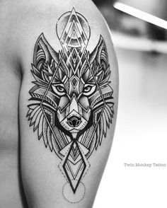 a black and white photo of a wolf tattoo