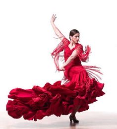 a woman in a red dress is dancing