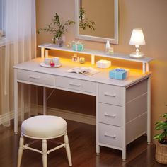 a white desk with a mirror and stool