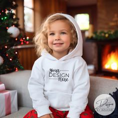 Introducing our baby toddler holiday sweatshirt mockup! A perfect mock for a diverse Christmas or New Years design, and more! Our mockup is ideal for Gildan 18500, Bella Canvas, Comfort colors 1567, or universal brands. Compliment your unique design this holiday season featuring this high quality digital mockup, showcasing an toddler / child modeling a white Hoodie Pullover Sweatshirt with Christmas backdrop. This mockup will help spread the holiday cheer in your Etsy shop while elevating your d White Hooded Sweatshirt Gift, Customizable White Hoodie For Gift, Customizable White Hoodie As Gift, Toddler Modeling, Holidays With Toddlers, Christmas Backdrop, Digital Mockup, Hoodie Mockup, White Pullover