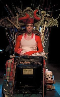 a man sitting on top of a chair with lots of wires attached to his head